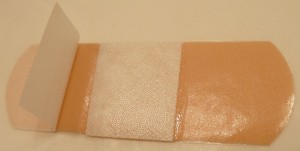 A self-adhesive bandage partially opened